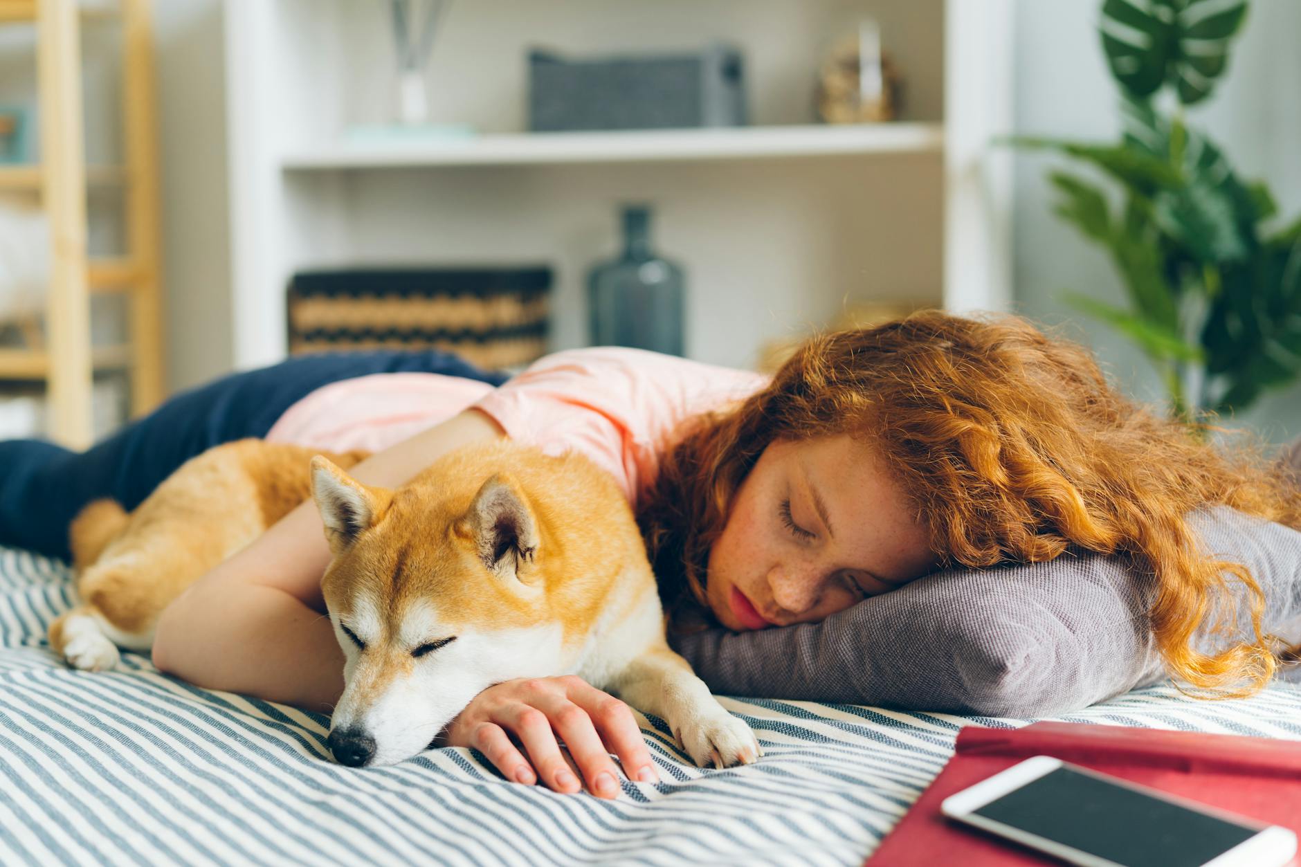 redhead woman sleeping with dog
